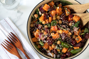 Pumpkin beetroot chickpea spinach salad in a bowl. Top view. Healthy vegan Thanksgiving dish.