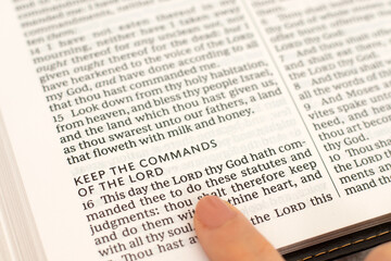 Obraz premium Commandments of the LORD text in open holy bible book. Christian obedience and faith in God Jesus Christ, biblical concept.