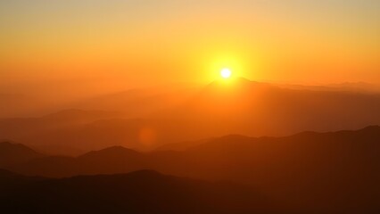 Obraz premium Golden sunrise over vast mountain peaks, creating a peaceful and expansive natural panorama.