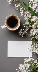 A cup of coffee, spring flowers, and a blank card on a gray surface