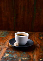Cup of coffee on rustic wooden background. Soft focus. Copy space	