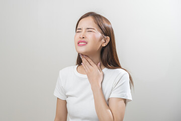 Sickness in inflaming asian young woman, girl use hand check self touch at sore throat, pain...