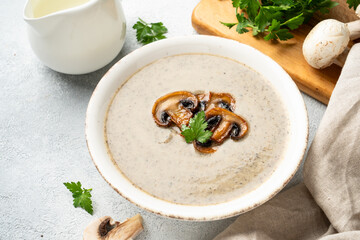 Mushroom soup puree on white kitchen table.