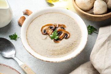 Mushroom soup puree on white kitchen table.