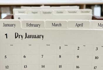 Dry January text in planner notebook on wooden background. 