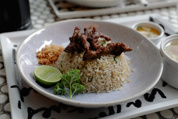 Paradise beef fried rice served with grilled beef slices, lime, parsley, and crispy shallots. Comes with clear soup and dipping sauce on the side. Close up