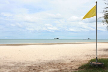A yellow flag placed on beach indicates 