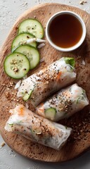 Fresh Vietnamese summer rolls with dipping sauce and cucumber.