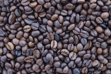 Close-up of roasted Arabica coffee beans. Background of brown roasted beans