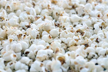 Flatlay of salted popcorn with cheese. Heap of homemade delicious popcorn on a rustic table