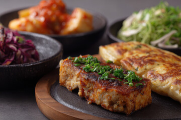 Savory Korean dishes with kimchi and pancakes on plates