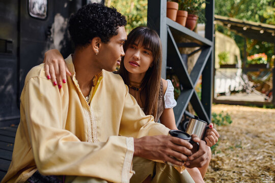 Young couple shares a sweet moment while glamping in nature