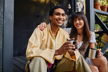 Young couple sharing smiles and moments while glamping in nature