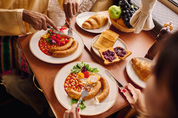 Young couple enjoying a delicious breakfast while glamping in a cozy setting