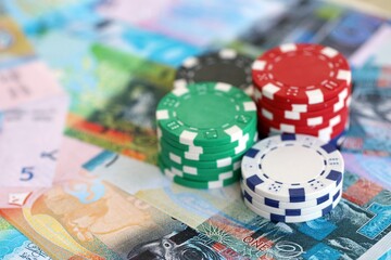 Kuwaiti dinar currency money bills and bunch of casino chips. The concept of gambling and casino