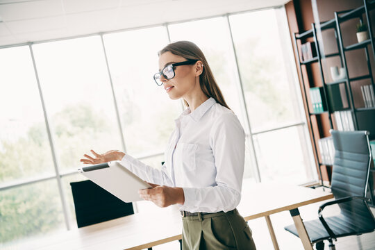 Confident businesswoman presenting a project in a modern office interior during a professional workspace meeting