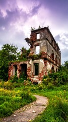 Abandoned, crumbling building, overgrown path