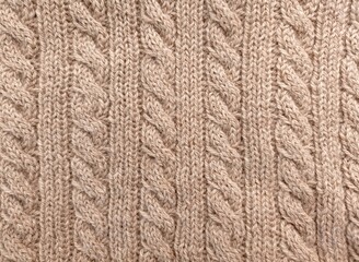Hand made beige cable stitch needlework from woolen yarn.