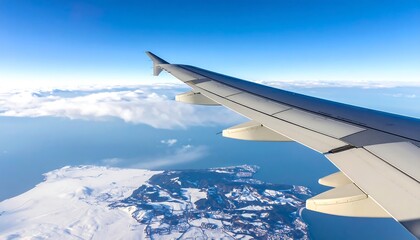 Airplane wing over snowy landscape