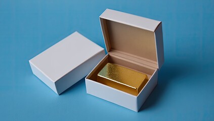 Gold bar presented in an open white gift box on a blue background.