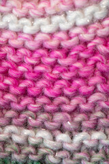 hand knitting pink wool close up of a knitted fabric