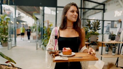 Charming Young Woman with Dessert in a Modern Caf