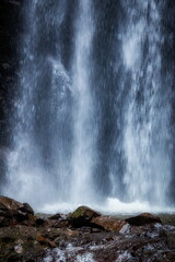 Vertical Waterfall over Mossy Rocks