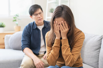 Family problem concept, Asian wife and husband sitting back to back in the living room at home have...