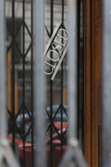 Closed Sign Behind Barred Door