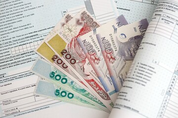 Nigerian naira money bills on tax form close up. Taxation and accounting concept