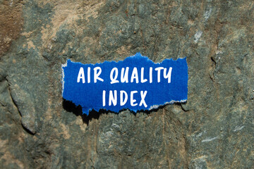 Air Quality Index message written on ripped torn blue paper on stone background. Conceptual Air Quality Index symbol. Copy space.