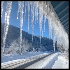 Icicles hanging from a roof on a snowy day