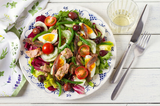 Mediterranean Tuna Salad. Nicoise Salad. White wooden background. High angle view