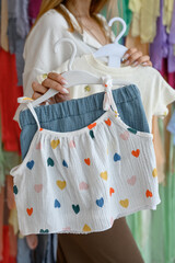 Children's clothing: a top with bright hearts and shorts © bo.kvk