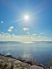 A Beautiful and Serene Lakeside View Situated Under Bright and Warm Sunlight, Perfect for Relaxation