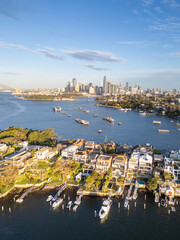 Sydney, Australia: Aerial view of the Birchgrove affluent suburb with the Sydney downtown district skyline in the background in Australia