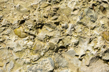 Weathered Stone Wall Texture Showing Cracks and Natural Patterns
