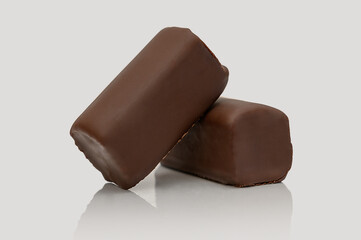 Cottage cheese bar in chocolate glaze. On a gray background. Sweet dessert.