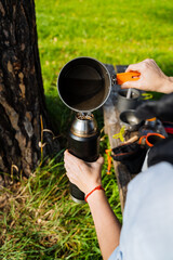 Fototapeta premium Brewing Coffee Outdoors Embracing and Cherishing the Most Relaxing Moments While Surrounded by Natures Abundant Beauty and Tranquil Serenity, Creating Lasting Memories of Adventure and Togetherness