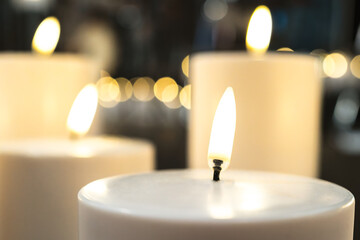 Shallow focus of a LED lit fake candle seen with out LED candles within a church setting. Safer than traditional wax candles.