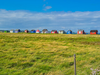 Charming and Colorful Coastal Cottages Nestled Beneath a Bright and Serene Sky Outdoors