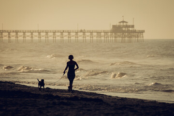 Jogging with a dog on the beach