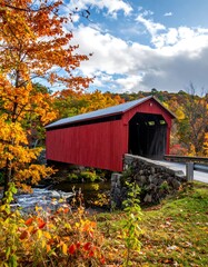 Autumnal red bridge over a stream