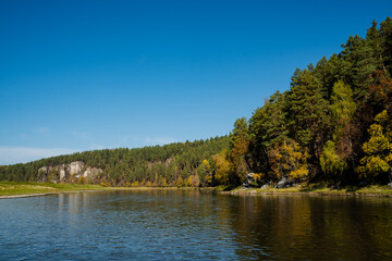 Imagine a serene lake surrounded by majestic trees, with sunlight sparkling on the waters surface. Its a perfect, inviting natural retreat for relaxation and rejuvenation