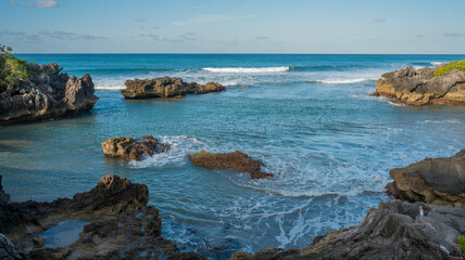 Waves crash against rocks in a hidden lagoon