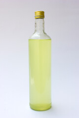 A transparent bottle with green liquid inside, isolated on white background. Can be used as a mockup for beverages or medical liquids or medicines in a bottle.