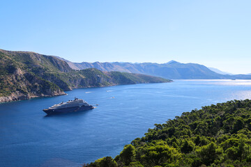 Luxury Cruise Ship Along Scenic Mountain Coastline