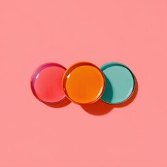 Three colorful circles on a pink background