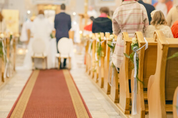 Naklejka premium White wedding aisle decoration with tulle and rose petals in church interior