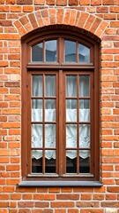Ornate wooden window in a brick wall